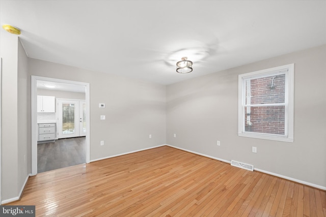 spare room with light hardwood / wood-style floors
