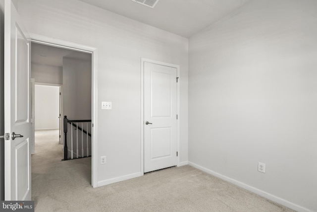 empty room featuring light carpet