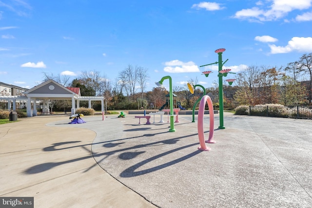 view of property's community featuring a playground and a pergola