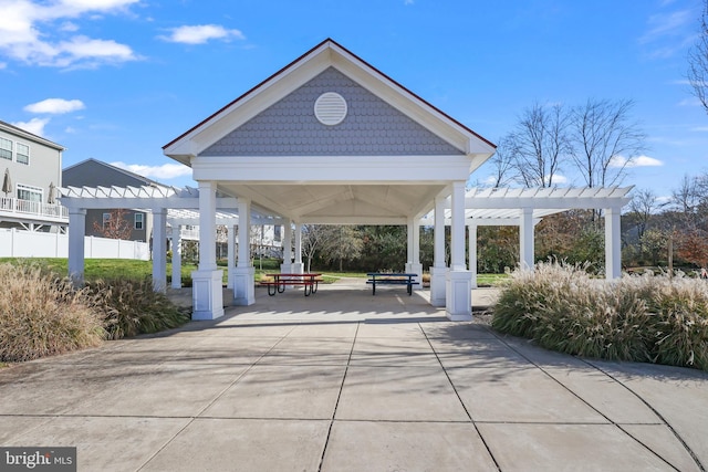 view of community with a gazebo, a pergola, and a patio