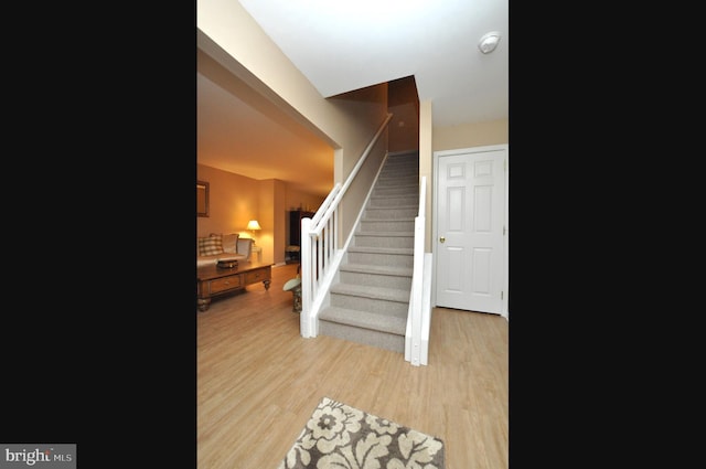 stairway featuring hardwood / wood-style floors