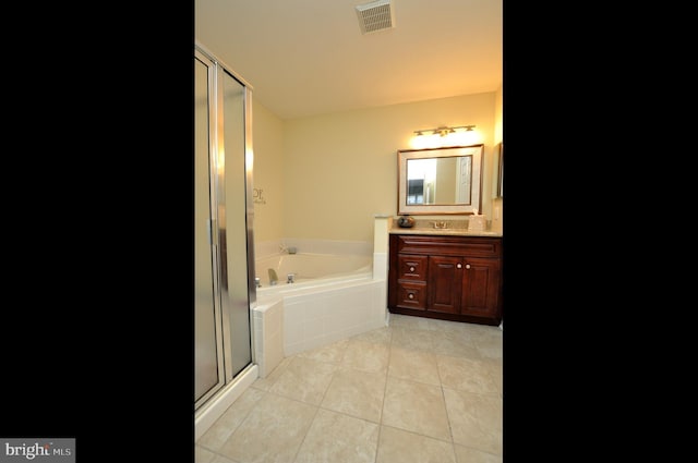 bathroom with tile patterned flooring, plus walk in shower, and vanity