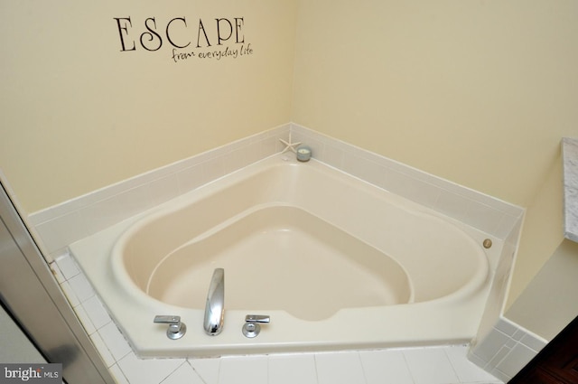 bathroom featuring a relaxing tiled tub