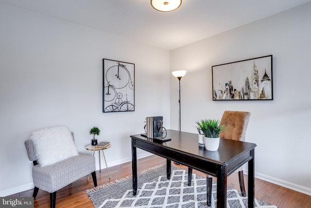 office area featuring baseboards and wood finished floors