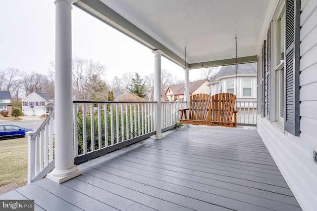 wooden deck with covered porch and a residential view