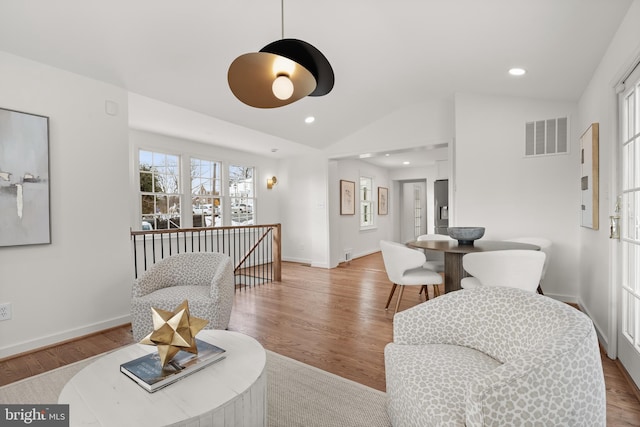 living room with light hardwood / wood-style flooring and lofted ceiling