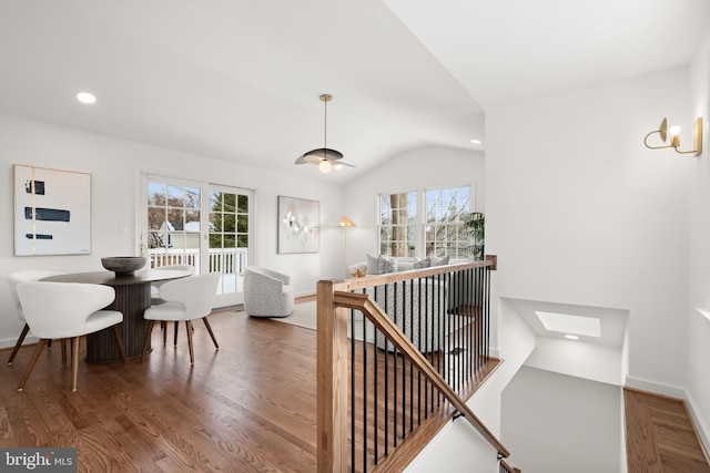 interior space featuring hardwood / wood-style flooring and lofted ceiling with skylight