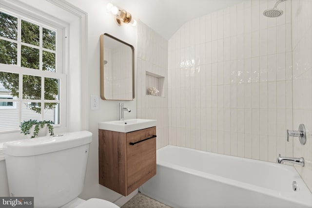 full bathroom featuring toilet, vanity, and tiled shower / bath