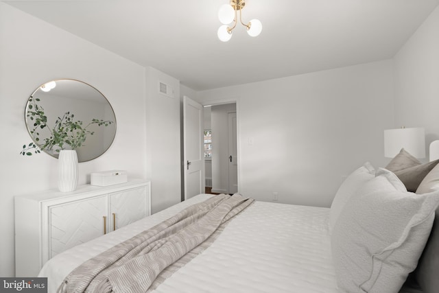 bedroom featuring a notable chandelier