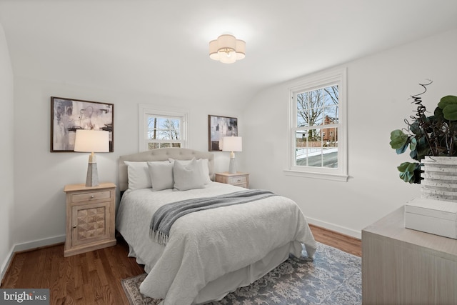 bedroom with dark wood-type flooring and vaulted ceiling