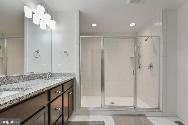 bathroom with vanity, an enclosed shower, and tile patterned flooring