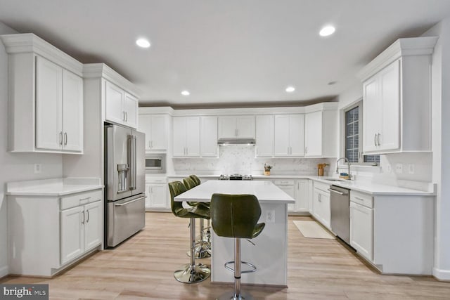 kitchen featuring stainless steel appliances, white cabinets, and sink