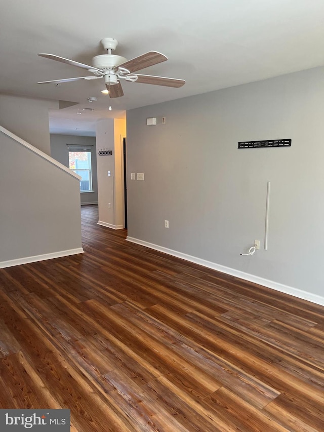 empty room with ceiling fan and dark hardwood / wood-style floors