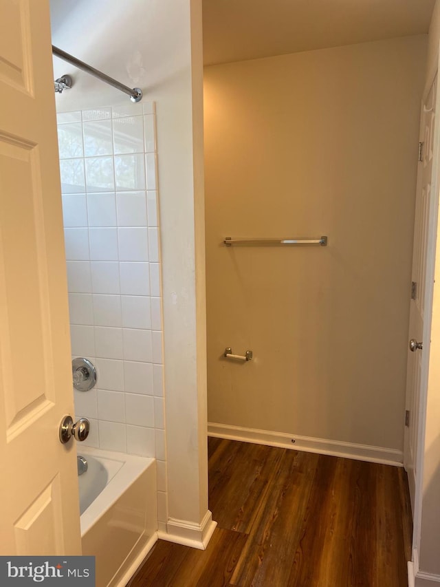 bathroom featuring tub / shower combination and hardwood / wood-style flooring