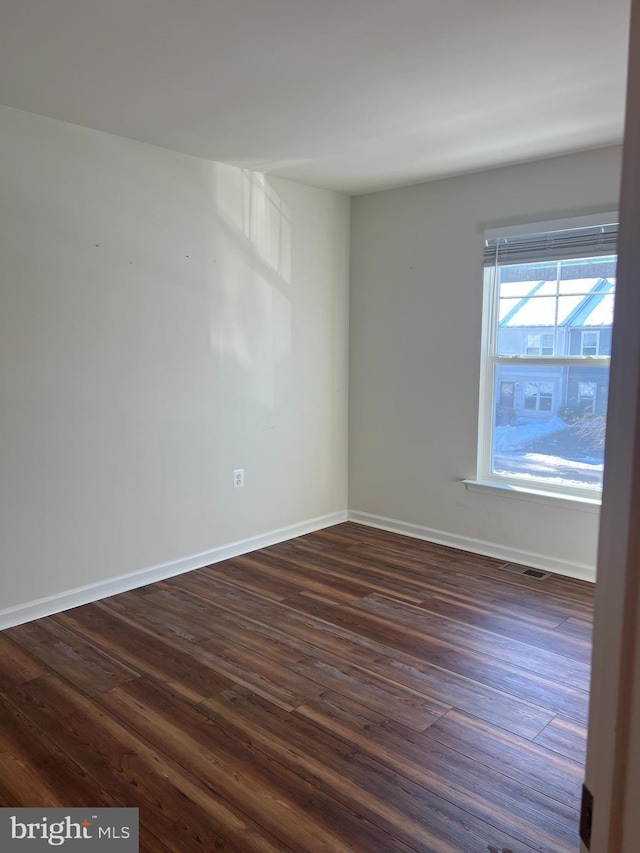 empty room featuring dark hardwood / wood-style flooring