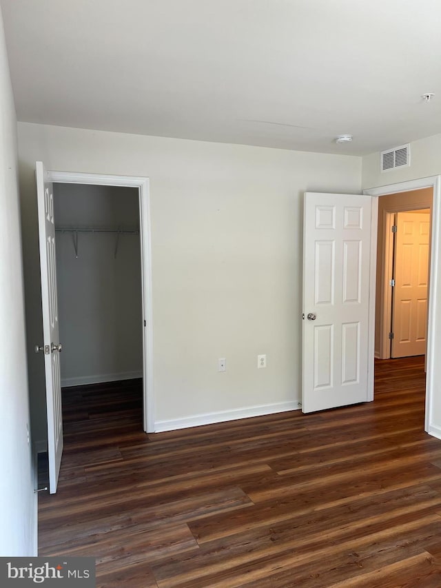 spare room featuring dark hardwood / wood-style flooring