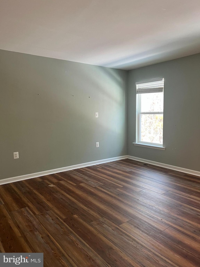 unfurnished room featuring dark hardwood / wood-style flooring