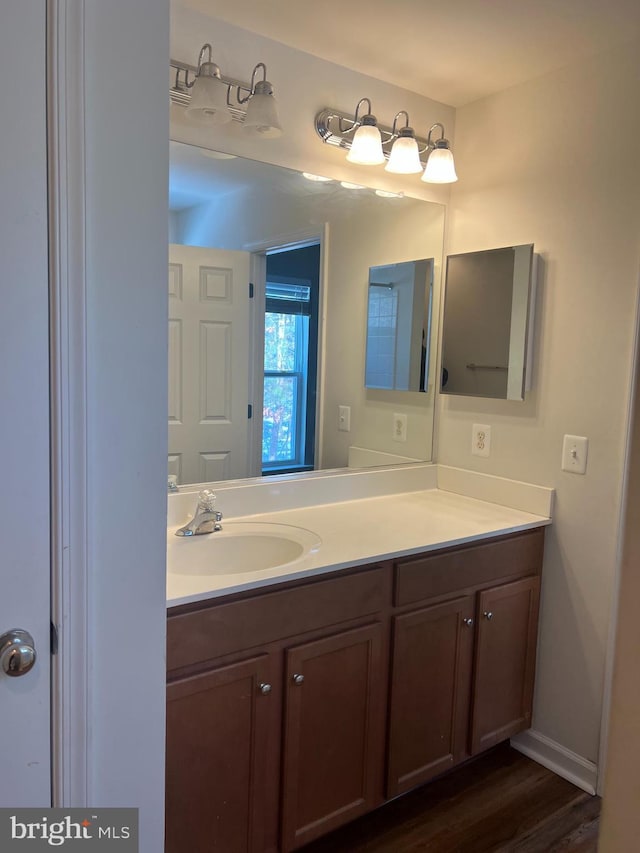 bathroom with vanity and hardwood / wood-style flooring