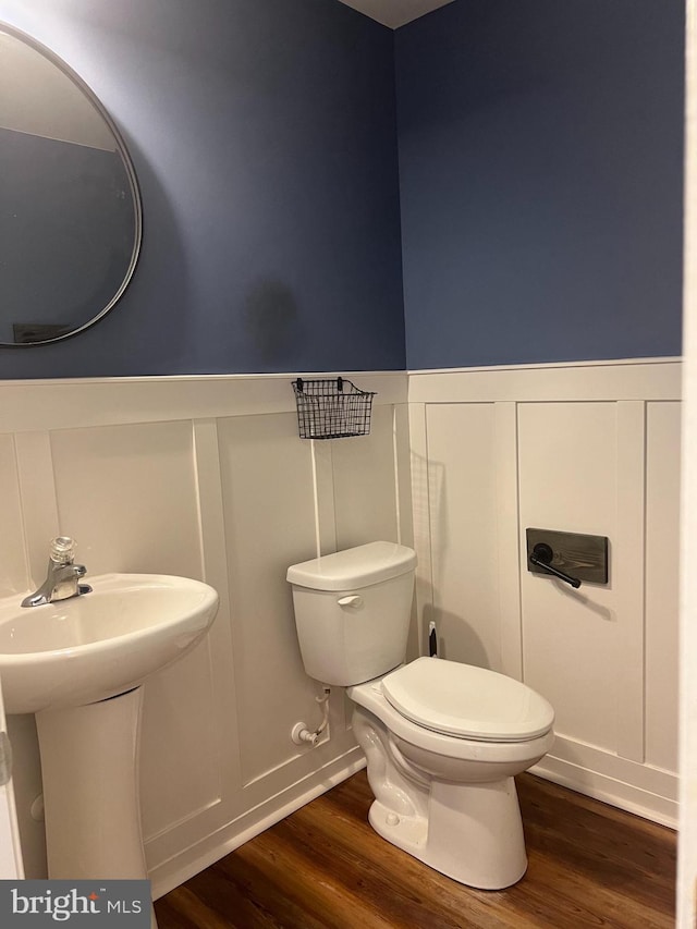 bathroom featuring toilet, sink, and hardwood / wood-style floors