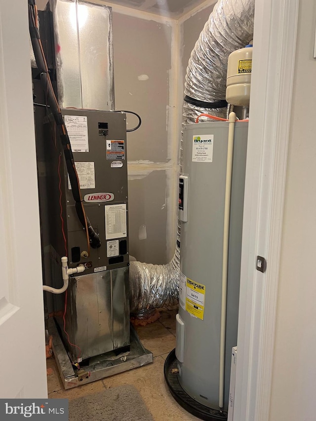 utility room featuring water heater