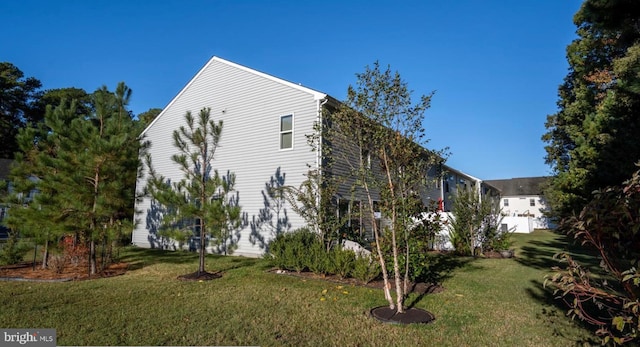 view of side of home featuring a yard