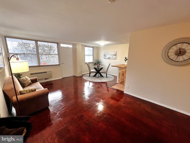 living room featuring dark hardwood / wood-style flooring and a wall mounted AC