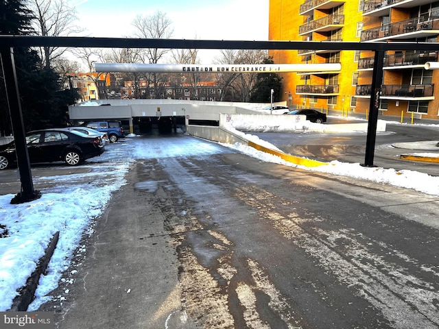 view of snow covered parking area