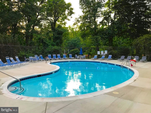 view of swimming pool featuring a patio area