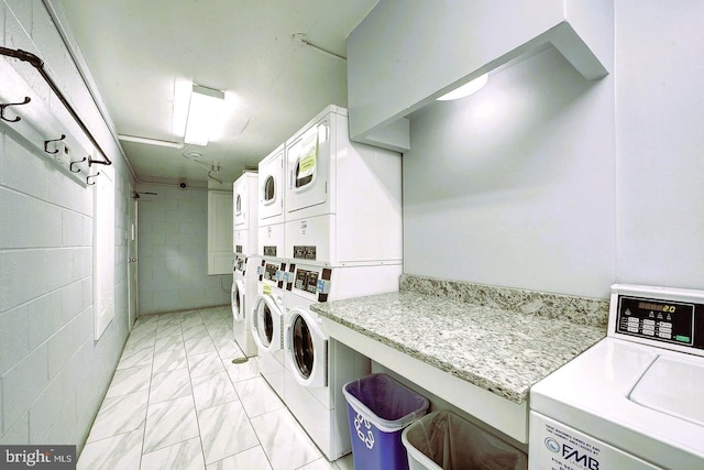 laundry area with washing machine and dryer and stacked washer / dryer