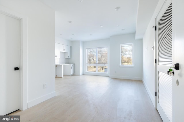 unfurnished living room featuring light hardwood / wood-style flooring