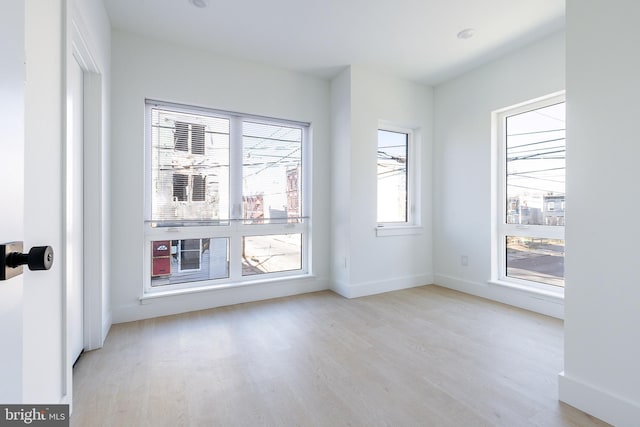 empty room with light hardwood / wood-style flooring