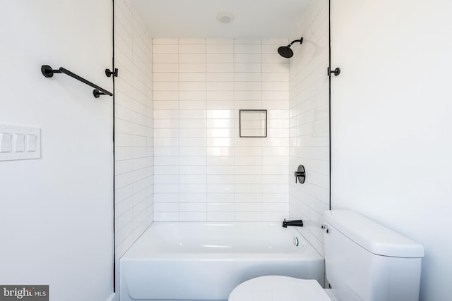 bathroom featuring toilet and tiled shower / bath combo