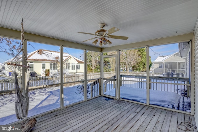 unfurnished sunroom featuring ceiling fan