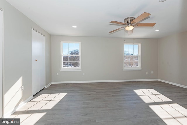 spare room featuring light wood-type flooring and ceiling fan