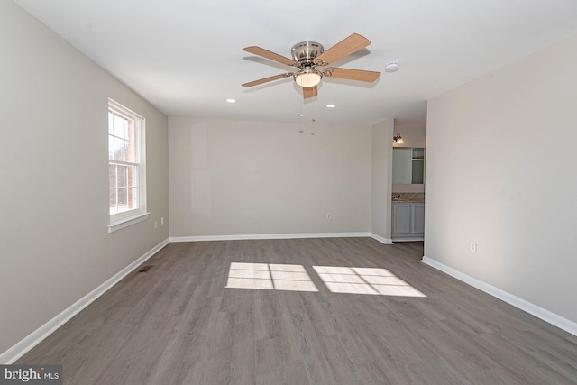 spare room with ceiling fan and hardwood / wood-style flooring