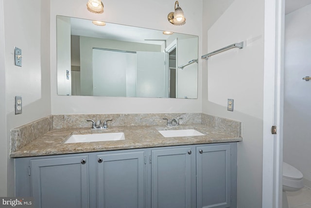 bathroom featuring toilet and vanity