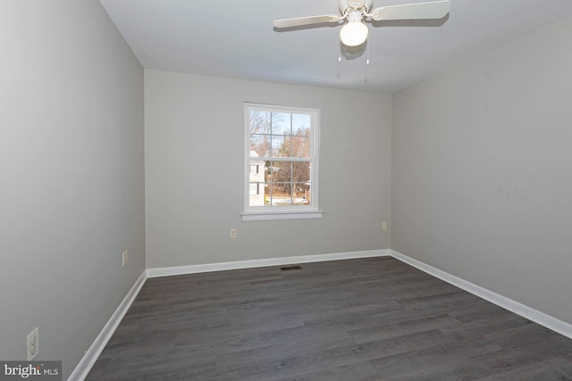 empty room featuring ceiling fan and dark hardwood / wood-style flooring