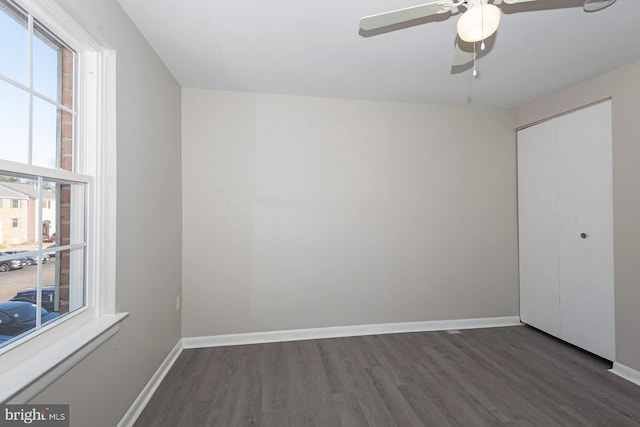 spare room featuring ceiling fan and dark hardwood / wood-style flooring