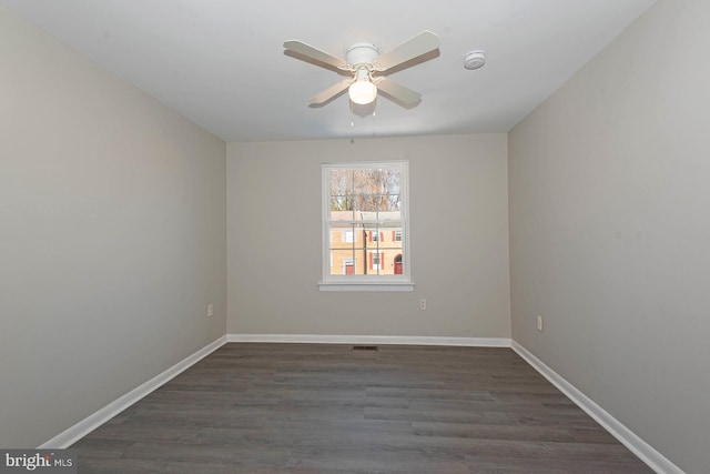 spare room featuring ceiling fan and dark hardwood / wood-style flooring