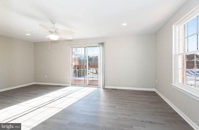 empty room with ceiling fan and dark wood-type flooring