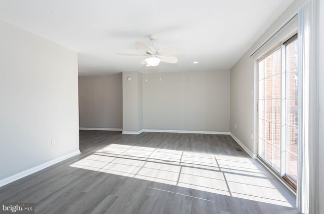 empty room featuring ceiling fan and dark hardwood / wood-style flooring