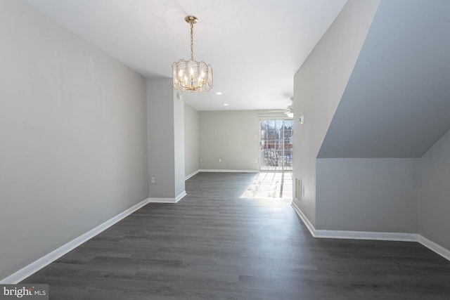 interior space featuring ceiling fan with notable chandelier and dark hardwood / wood-style floors