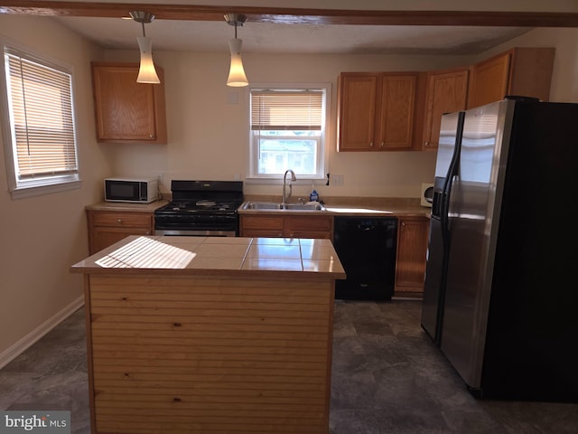 kitchen with stainless steel fridge with ice dispenser, range with gas cooktop, dishwasher, hanging light fixtures, and sink