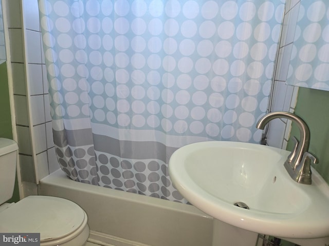 full bathroom with sink, toilet, and shower / bathtub combination with curtain