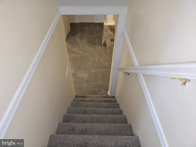 stairs featuring carpet