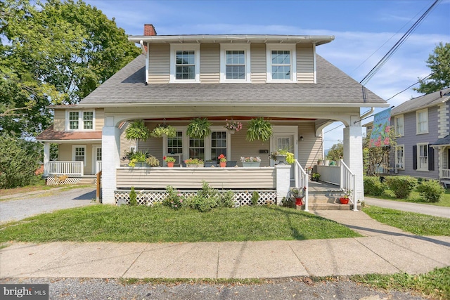 view of front of home featuring a porch and a front lawn