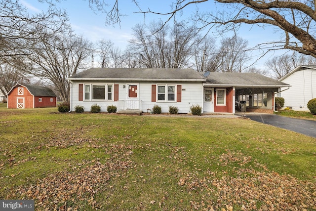 ranch-style home featuring a carport and a front lawn