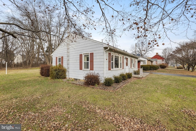 view of property exterior with a yard