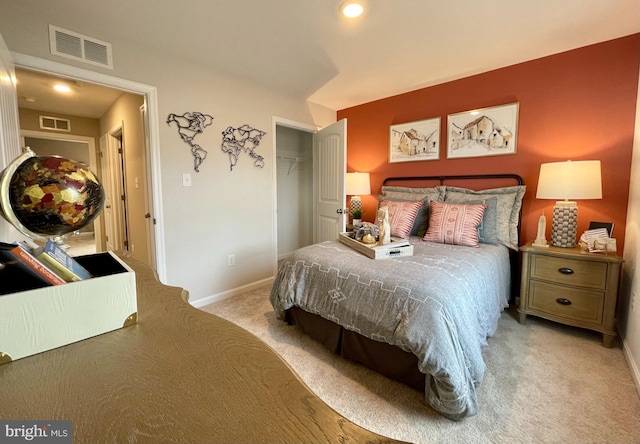 bedroom featuring light colored carpet and a closet