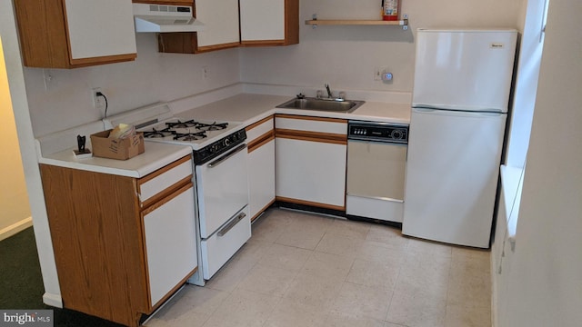 kitchen with sink, white appliances, and white cabinetry